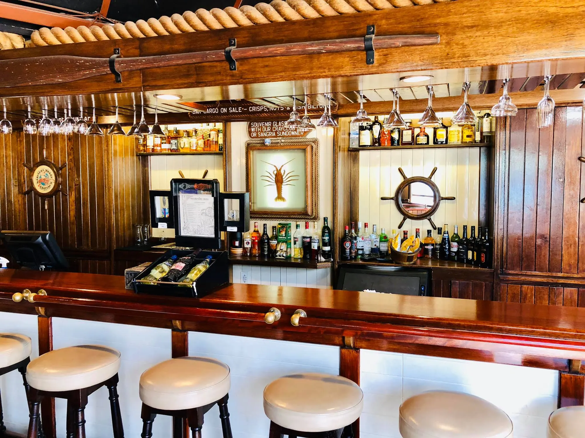 The wood-panelled Crayclub bar with brass rail and leather stools