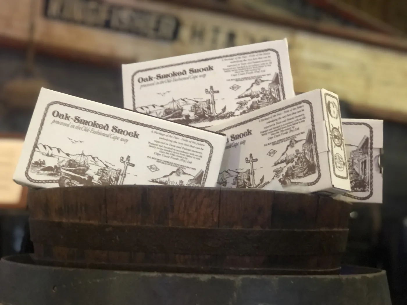 Boxes of Cape Coast oak-smoked snoek in a wooden barrel