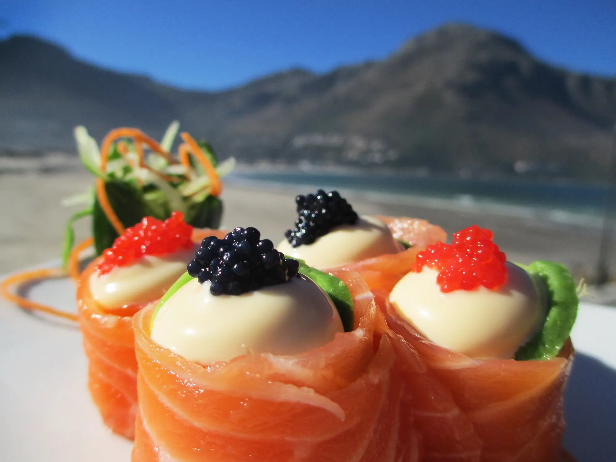 Salmon roses with caviar, with the Hout Bay mountains behind